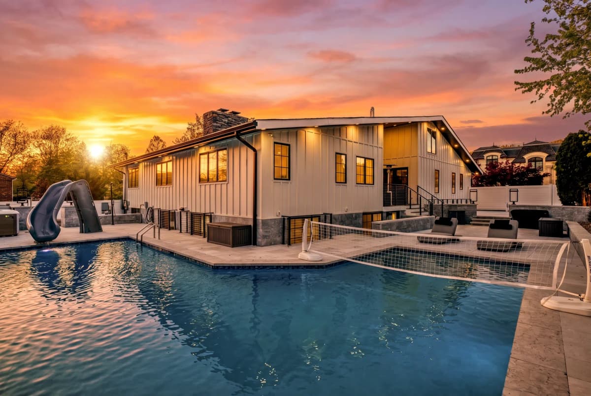Major renovation — Englewood, NJ — rear exterior at dusk with pool and patio