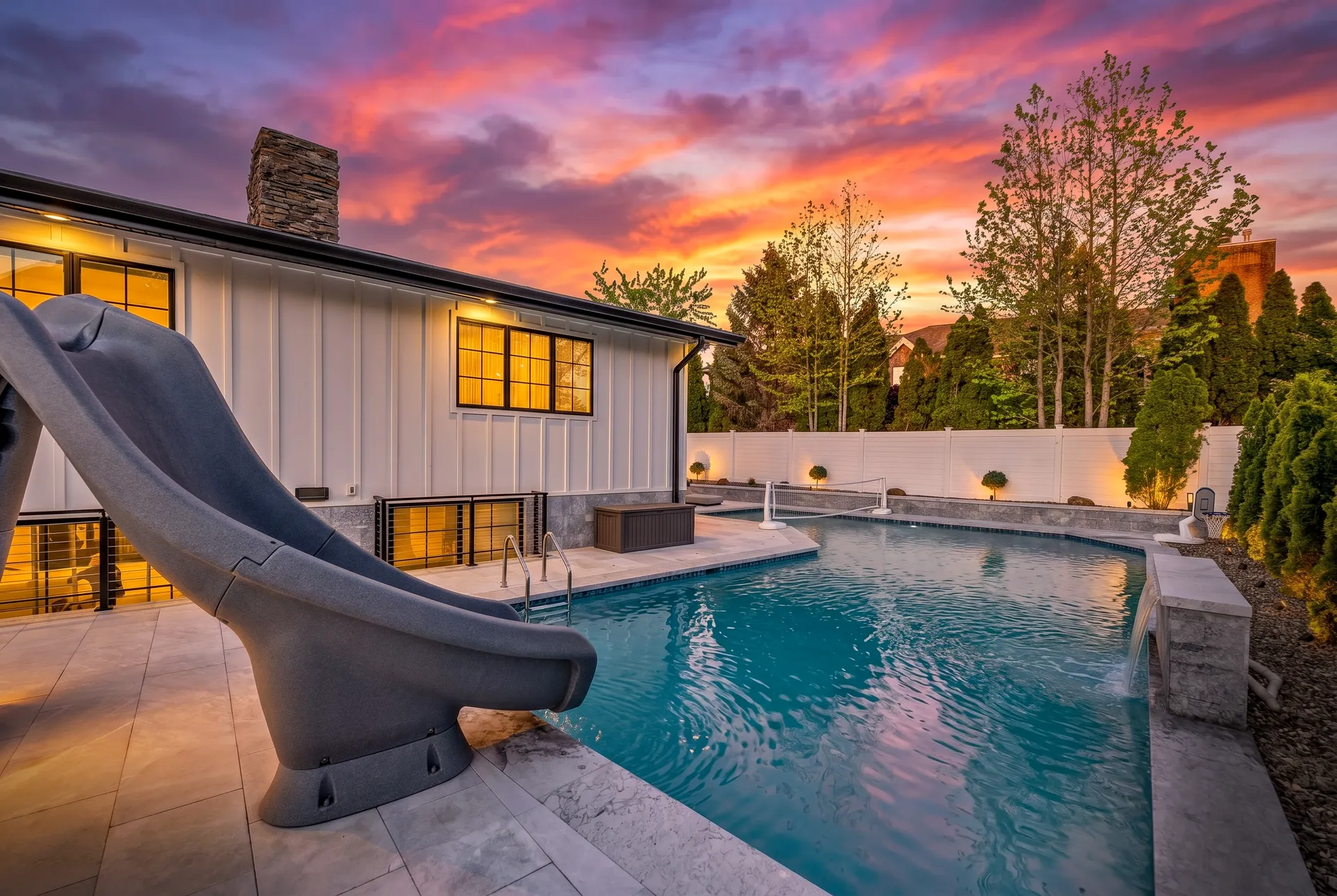 Resort backyard pool at twilight after renovation