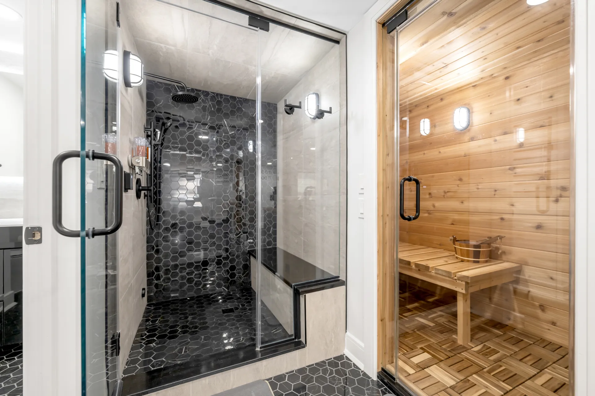 Black hex-tile steam shower beside a cedar sauna — Englewood, NJ