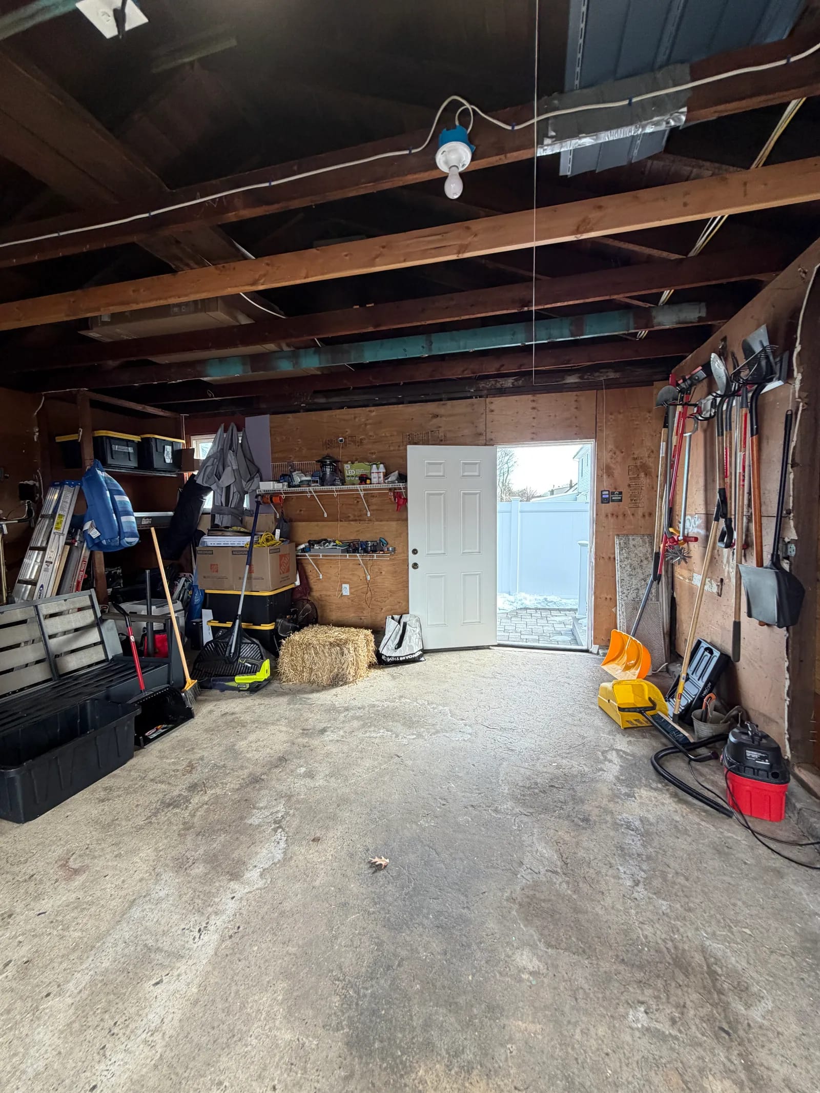 Original garage interior packed with storage before the rebuild