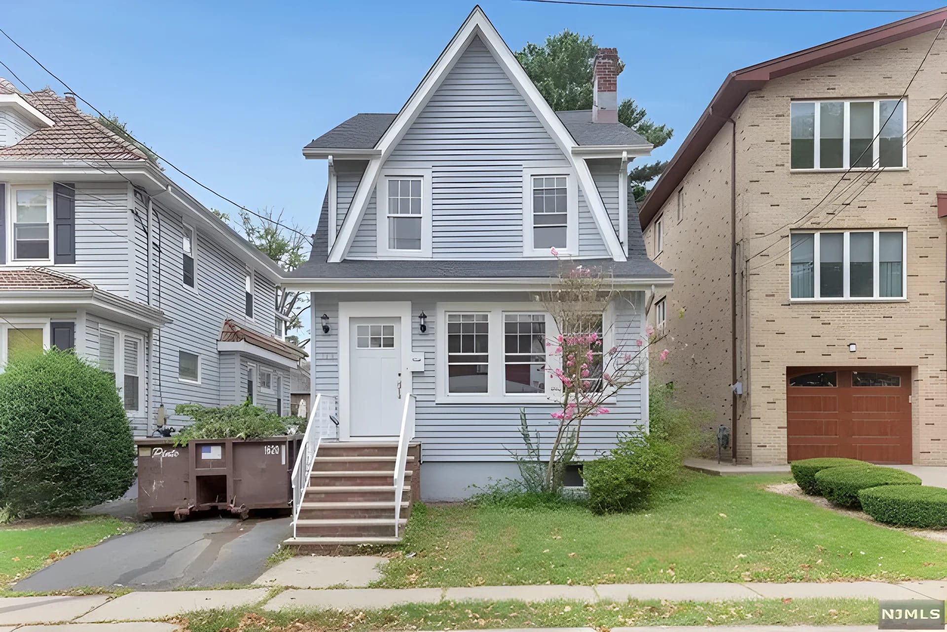 Full-gut renovation — Cliffside Park, NJ — renovated front exterior with new siding and landscaped entry