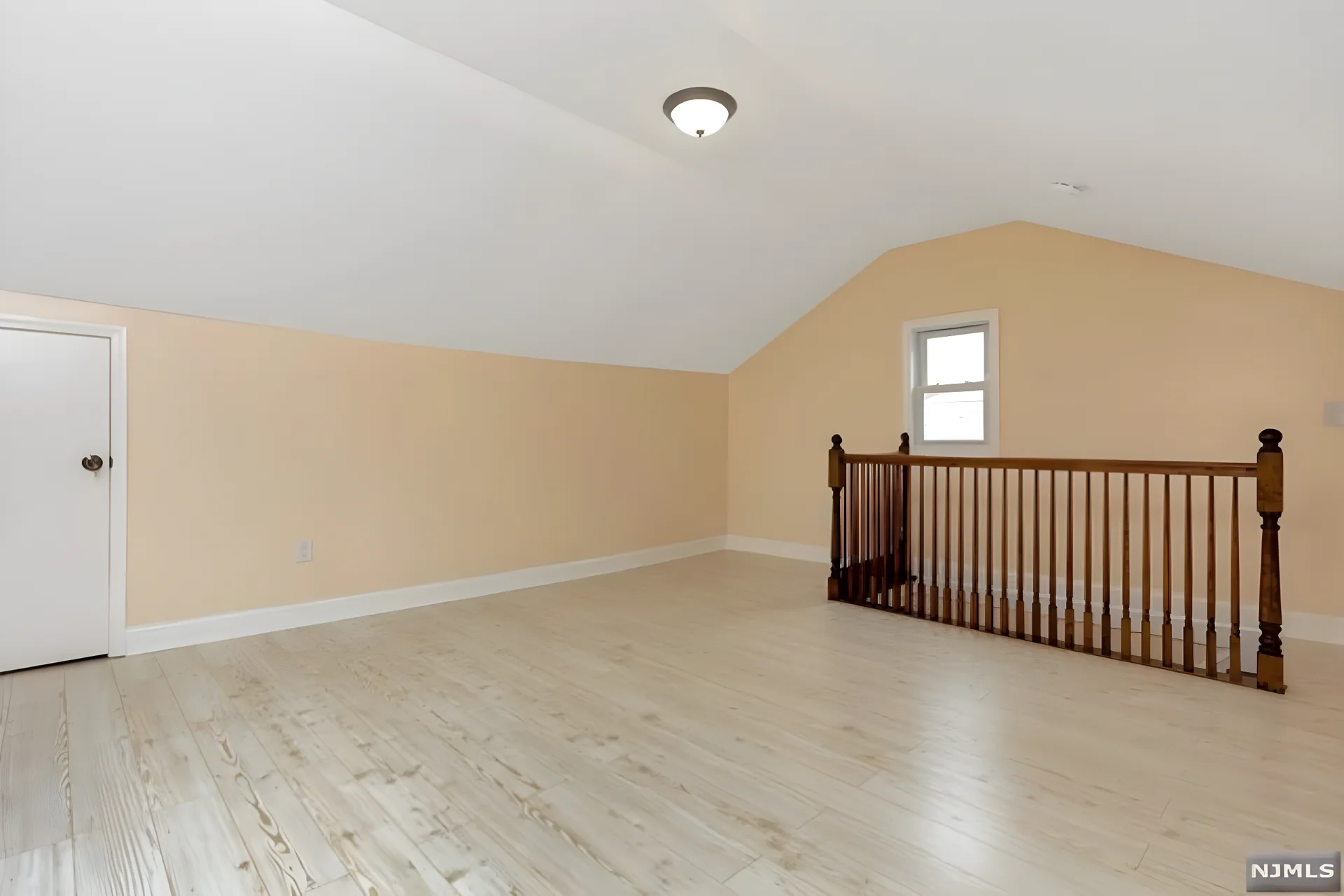 Finished attic level — bright bonus space with new flooring