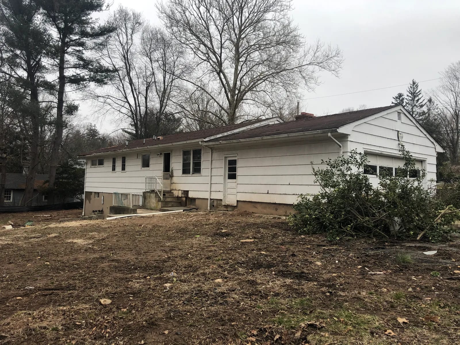 Original ranch home from the rear yard before demolition