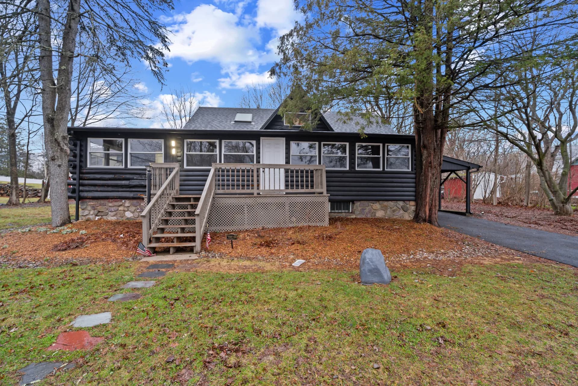 Log cabin renovation — West Milford, NJ — restored exterior with black stain