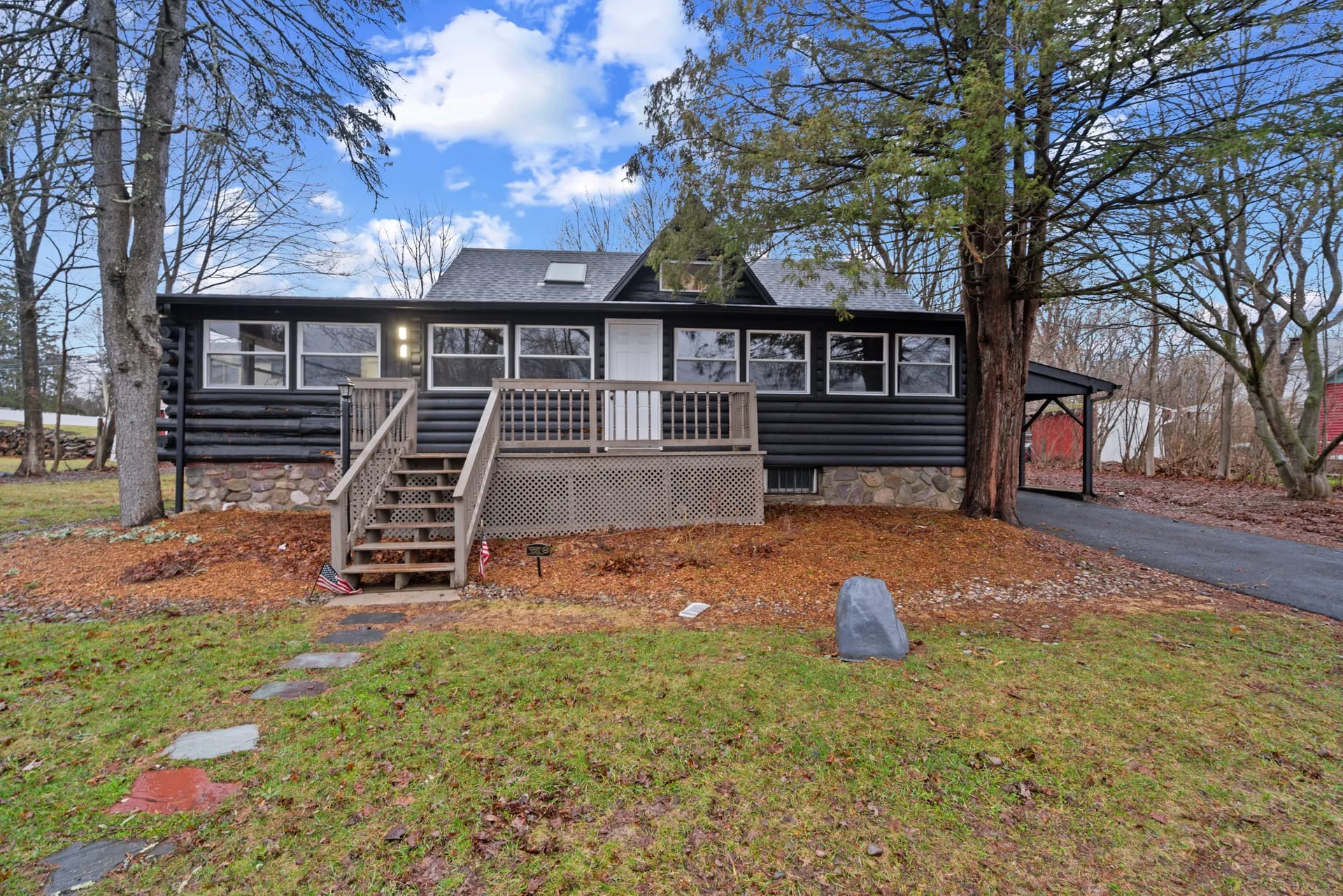 Log cabin renovation — West Milford, NJ — restored exterior with black stain