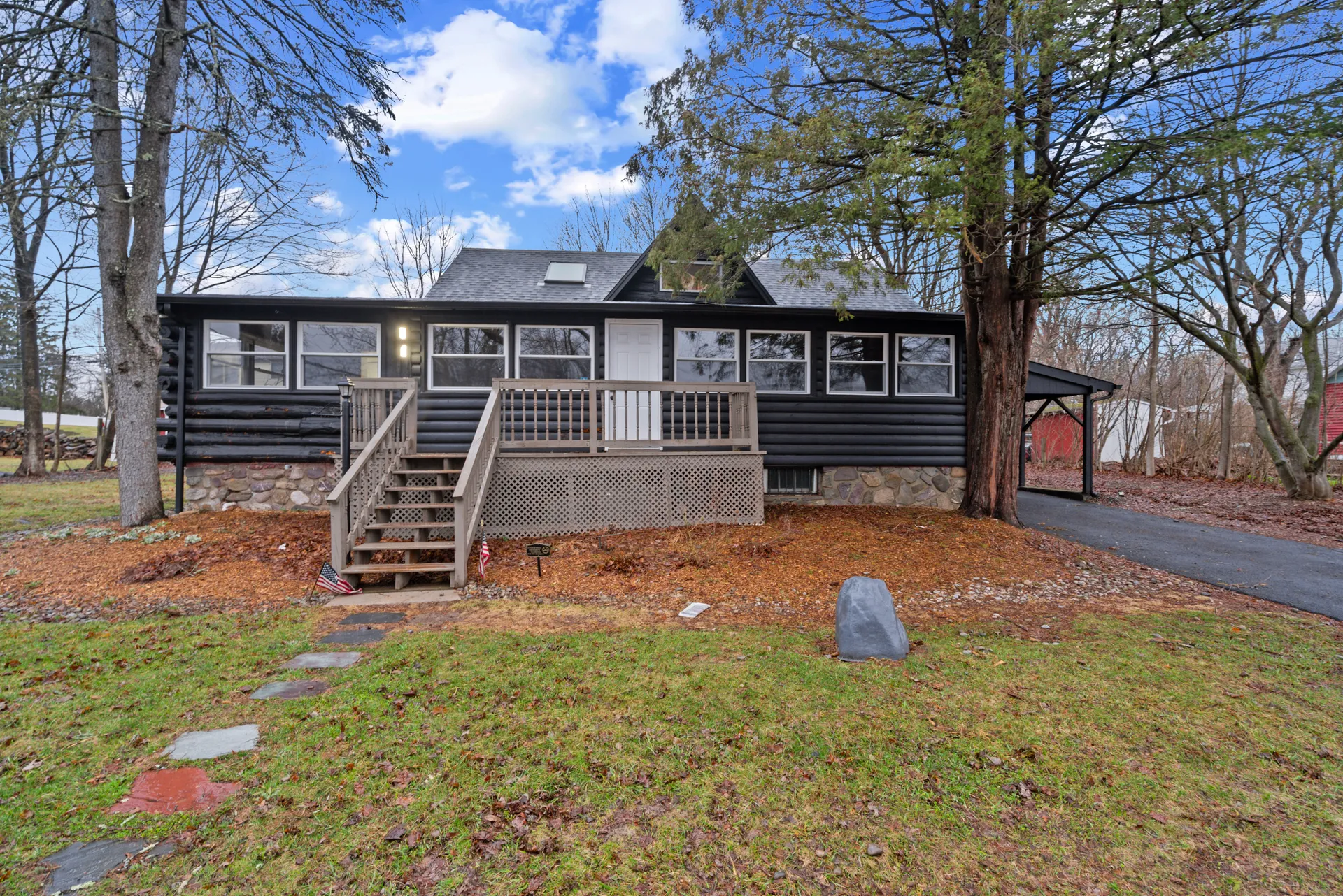 Log cabin renovation — West Milford, NJ — restored exterior with black stain