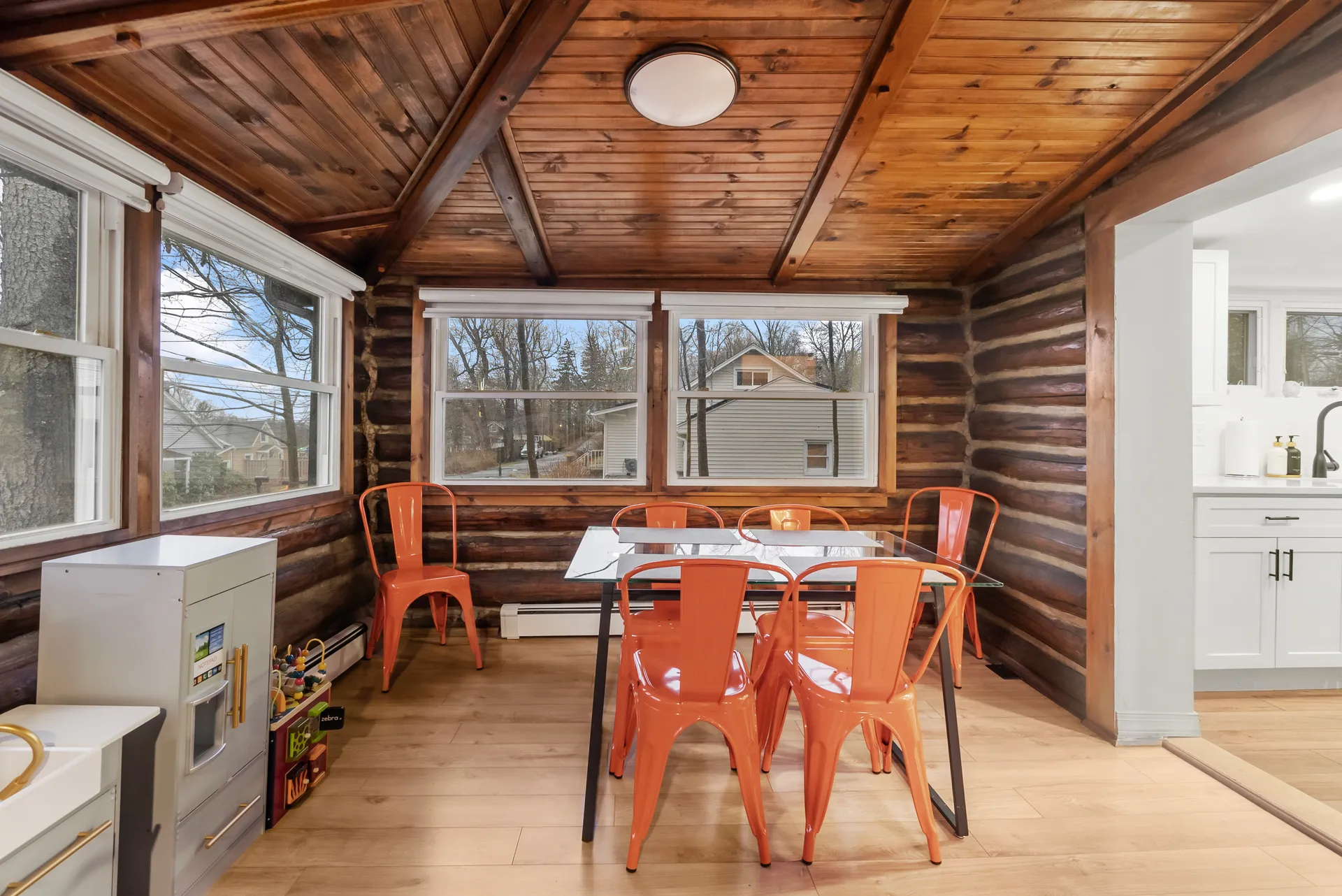 Finished sunroom dining area with kitchen pass-through