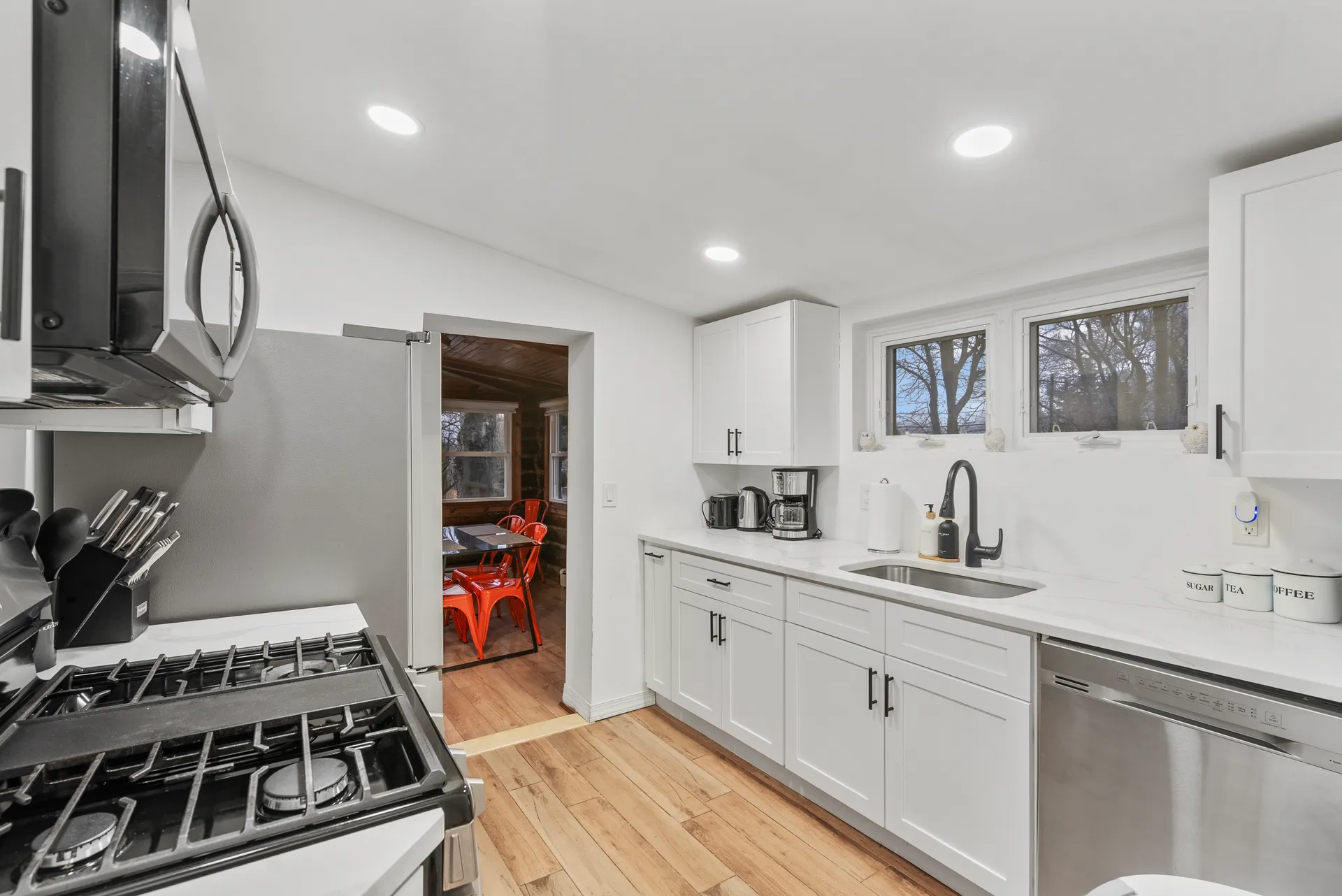Finished kitchen — white cabinetry, quartz counters, stainless appliances