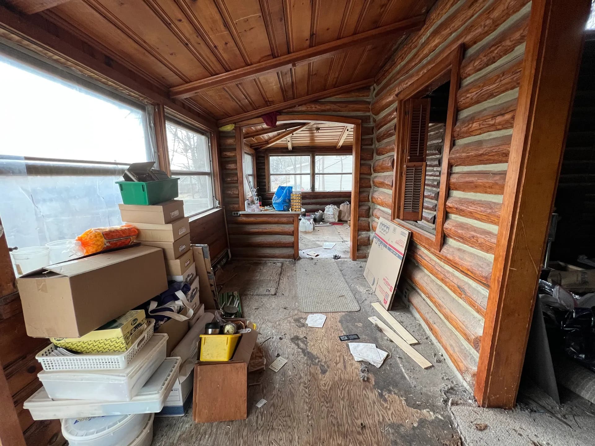 Original sunroom piled with debris before renovation