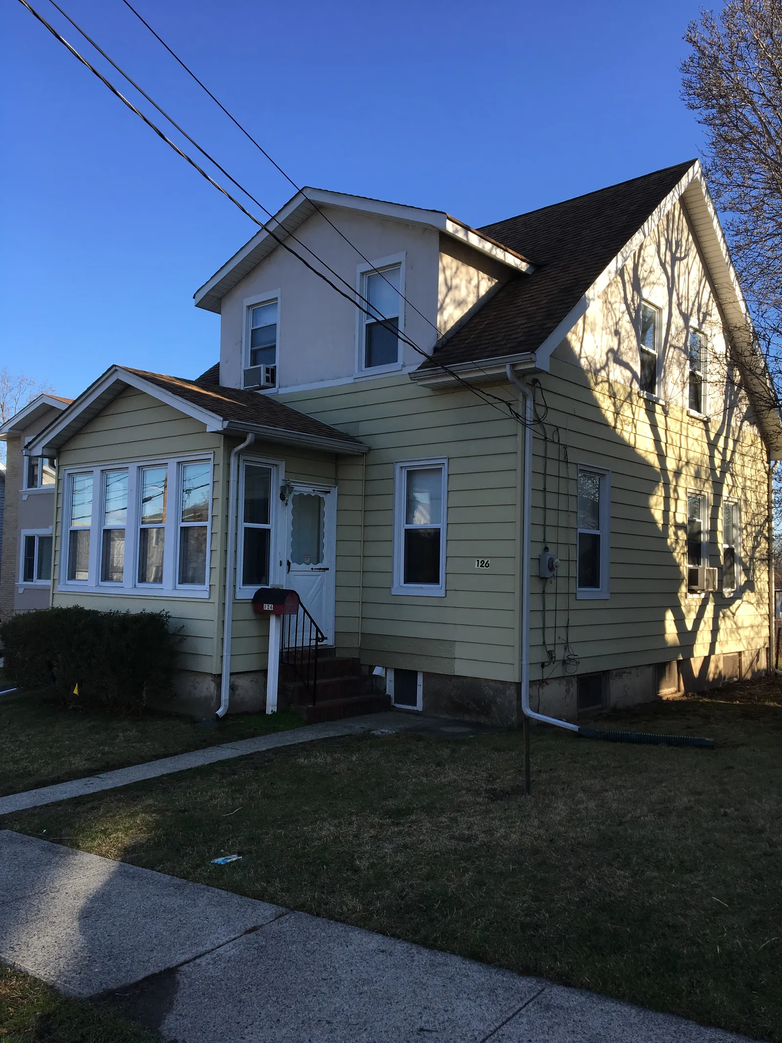 Elmwood Park home before renovation — original yellow siding