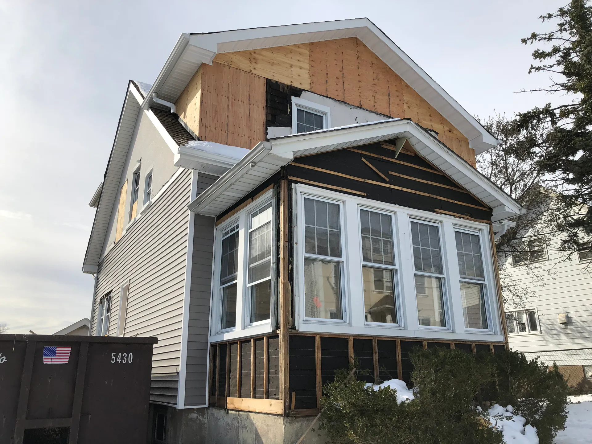 New siding and windows being installed during renovation