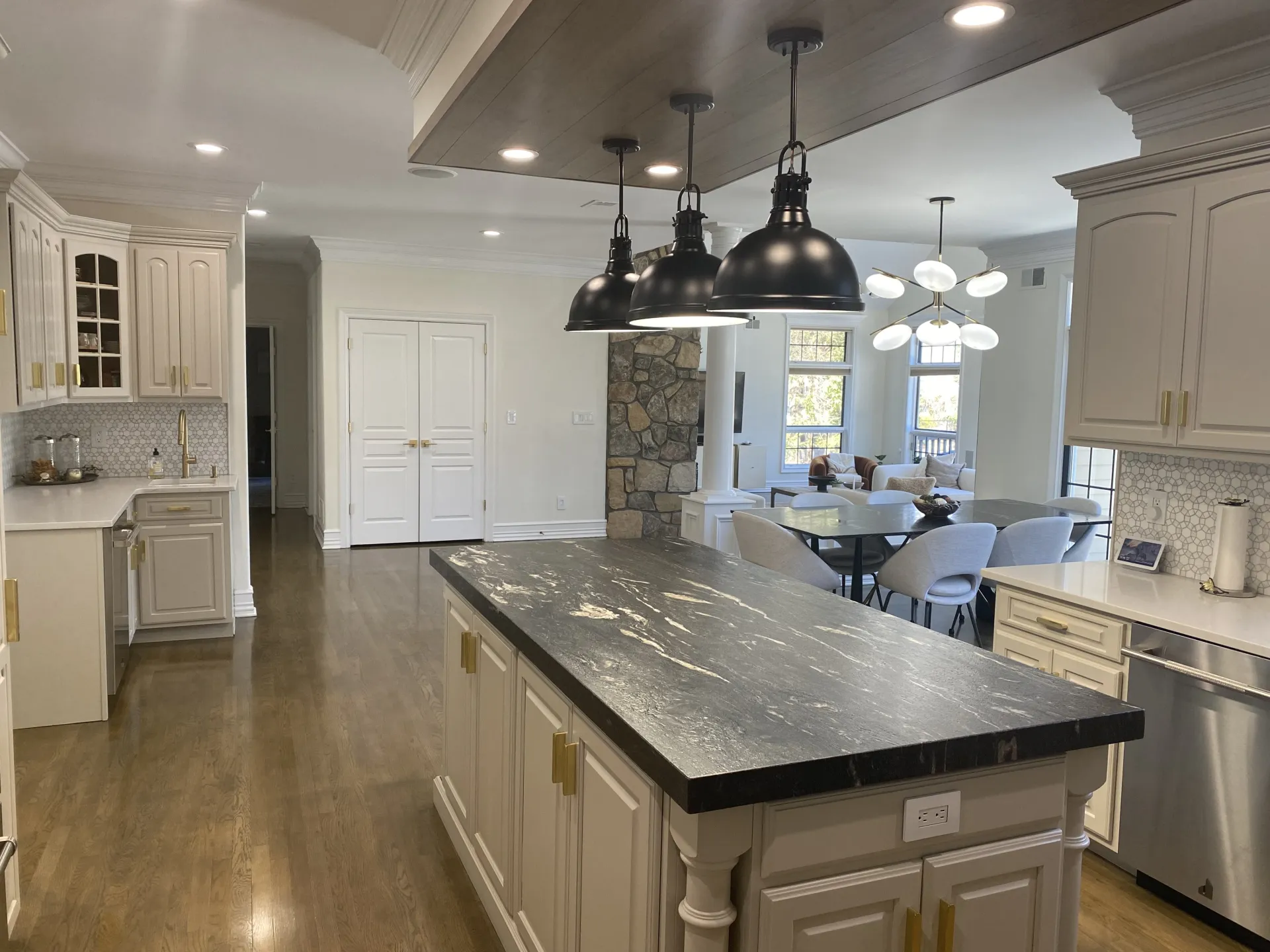 Kitchen toward the family room after renovation — same viewpoint, fully refinished
