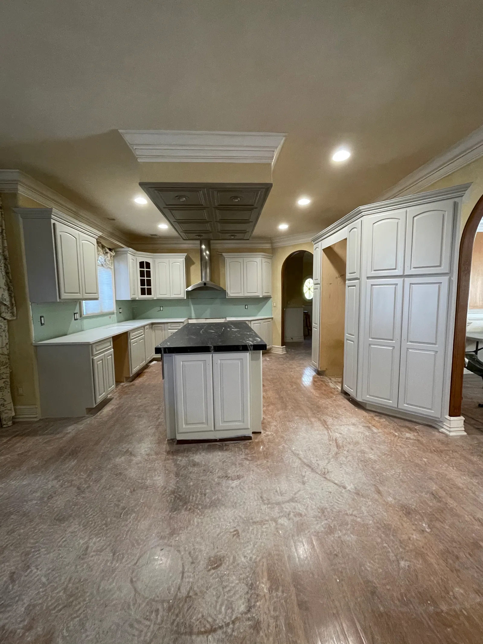 Kitchen during renovation — cabinets painted, counters set